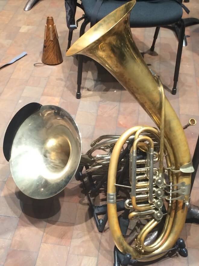 A Wagner tuba in front of a regular French horn.