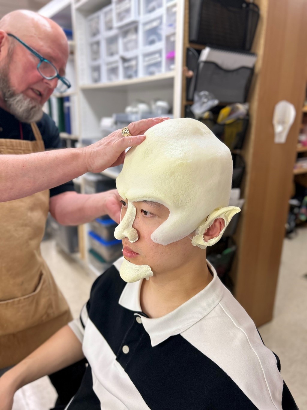 Tim Santry fitting Zhengyi Bai’s prosthetic pieces.