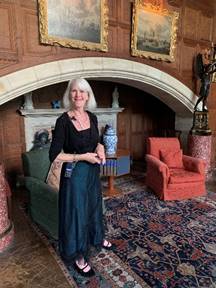 House Manager Jules Crocker in the Organ Room, with the entrance to the original theater in a small door behind the red chair!
