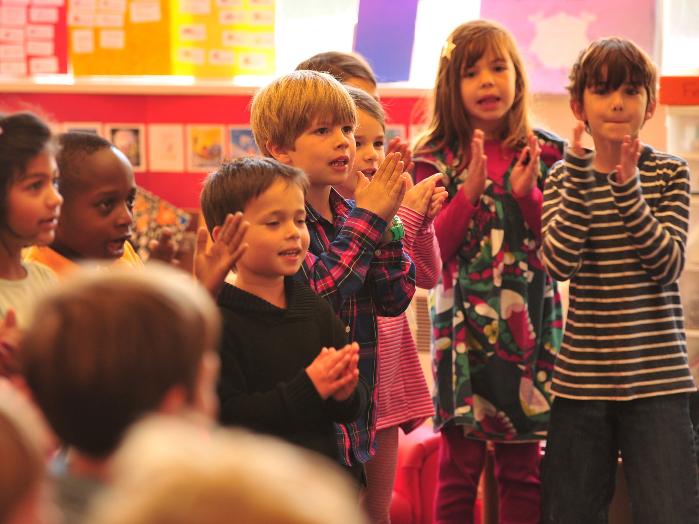 Children in a classroom clapping